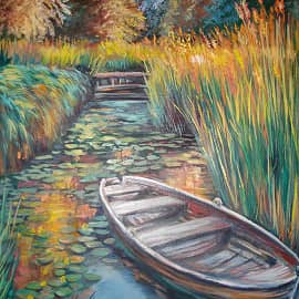 На воде. В камышах.